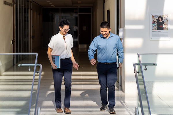 Two Students walking down stairs.